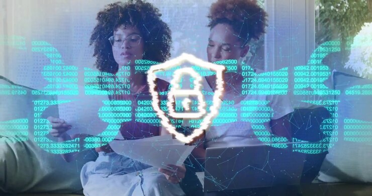 Two colleagues reviewing laptop with data overlay appearing glitch forming padlock securing data