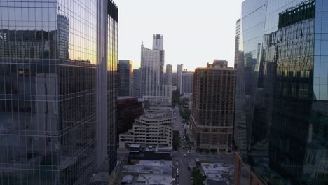 Aerial-view-revealing-the-west-4th-street,-between-reflecting-buildings-in-Austin,-sunset-in-USA---tracking,-drone-shot