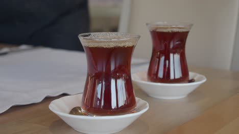 pouring turkish tea into traditional glass