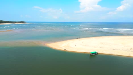 Devbag-beach-drone-moving-closeup-to-wide-from-river-in-malvan