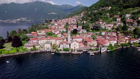 aerial orbit of beautiful torno village on lake como, italy