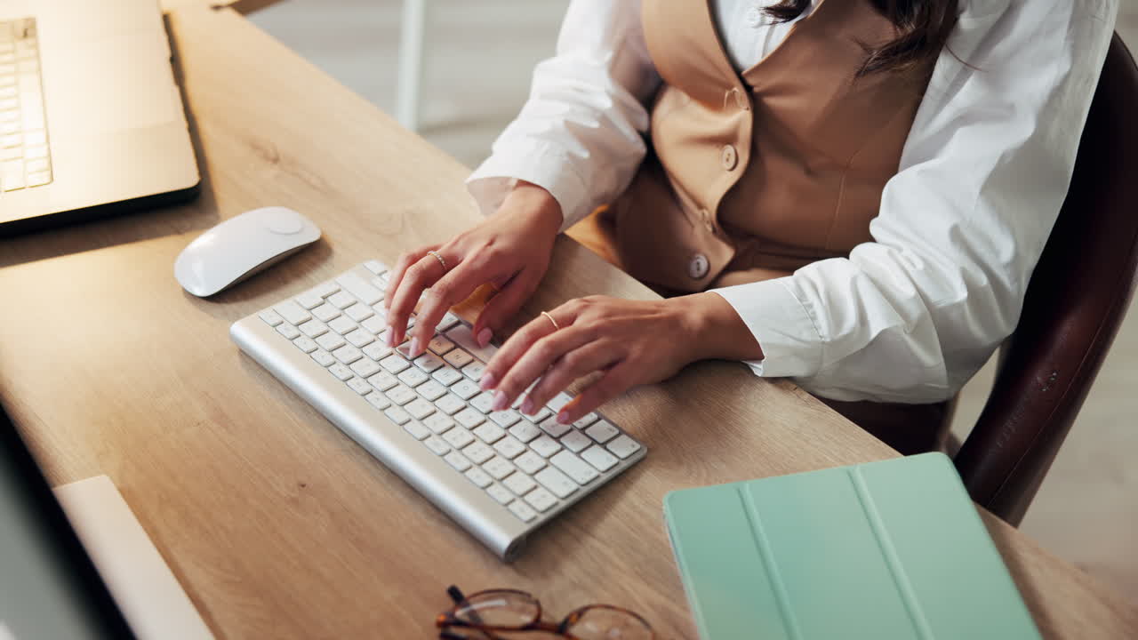 Woman typing on keyboard at desk
