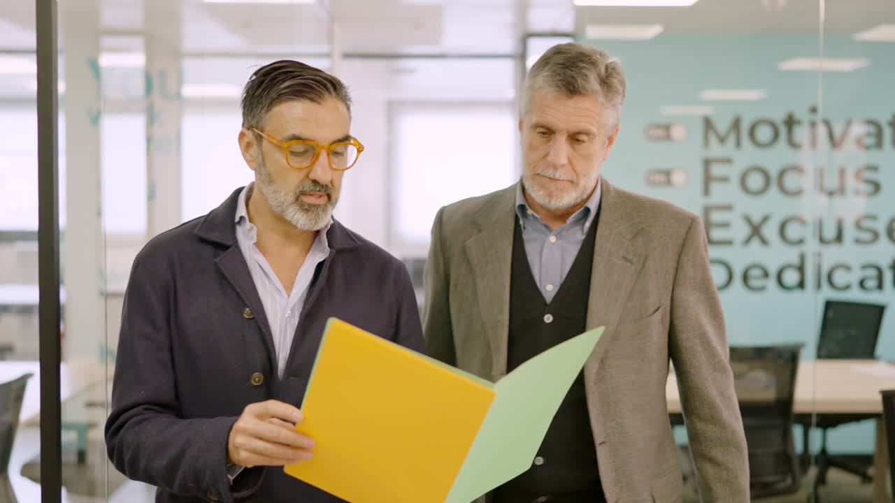 Businessmen walking while reading a financial report on paper