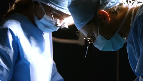 surgeons performing operation in operation room