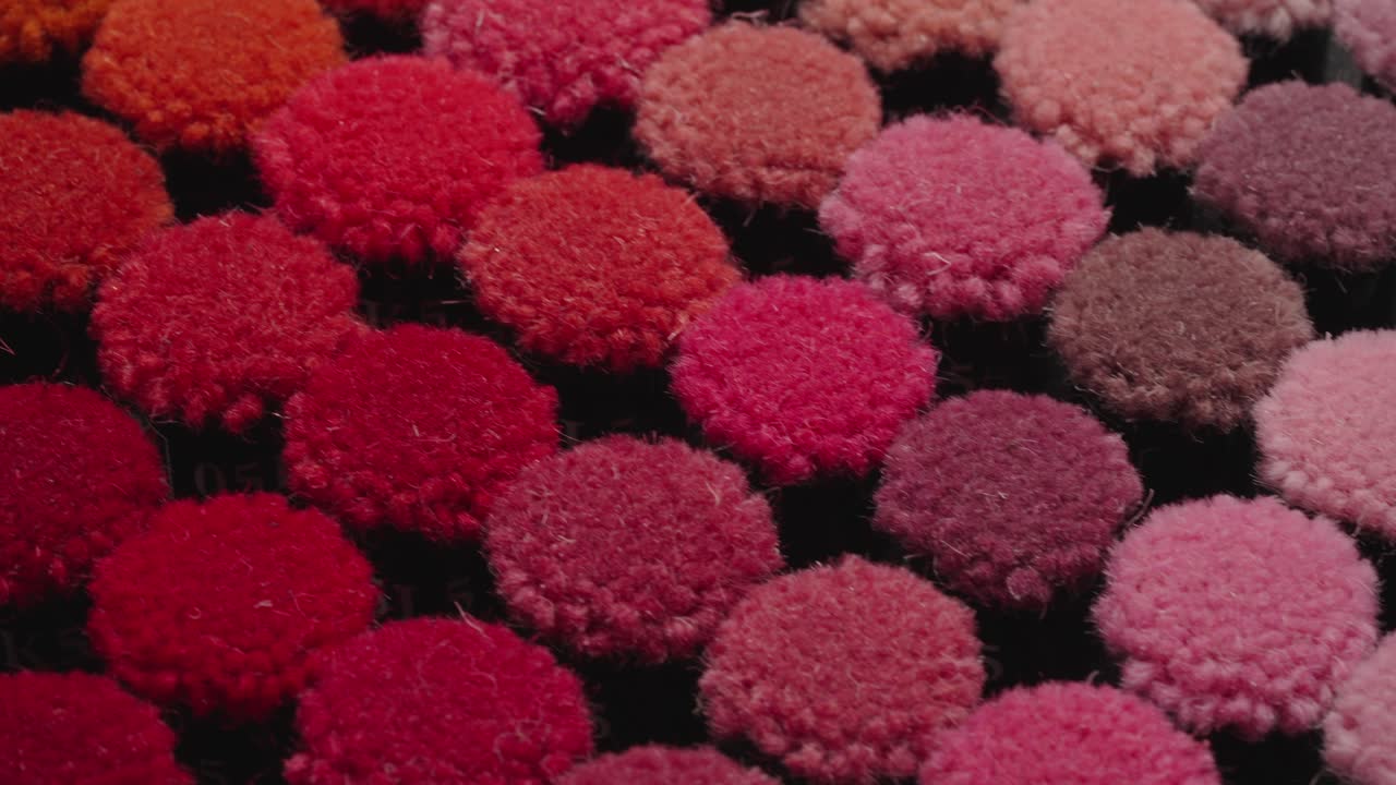 Collection of colorful carpet pile samples on tray moving in isometric view. Close up view. Textile industry concept.