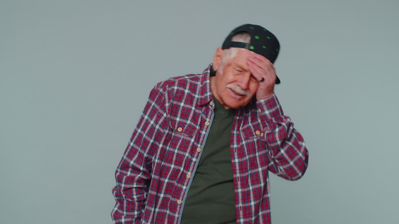 Upset tourist stylish man making face palm gesture, feeling bored, disappointed in result, bad news