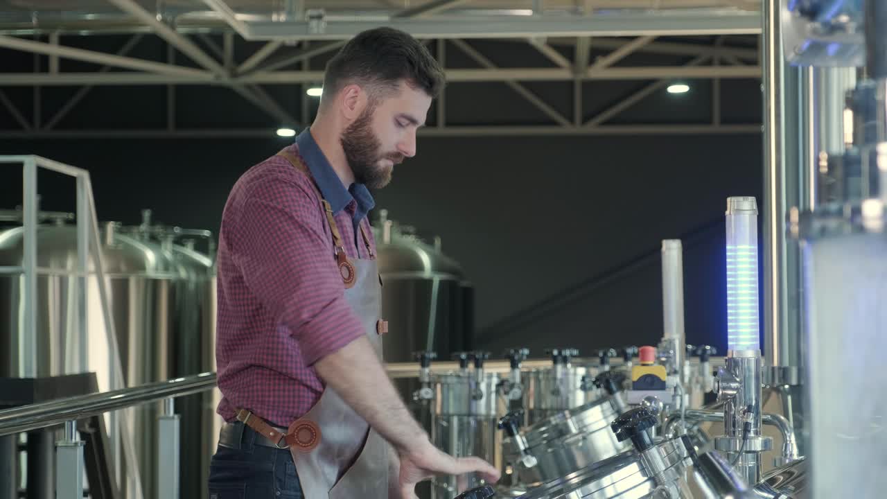 un joven cervecero con un delantal de cuero supervisa el proceso de fermentación de la cerveza en una fábrica de cerveza moderna
