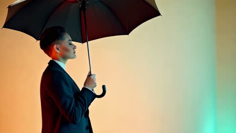 woman in suit holding an umbrella against a gradient background