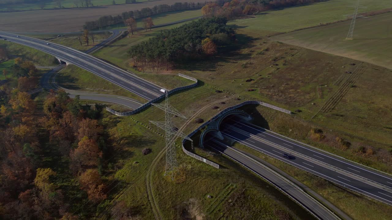 Ecoduct providing safe passage for wildlife over a german autobahn highway, seen from above. Nice aerial view flight circle drone footage