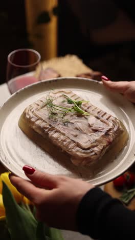 woman serving jellied meat dish