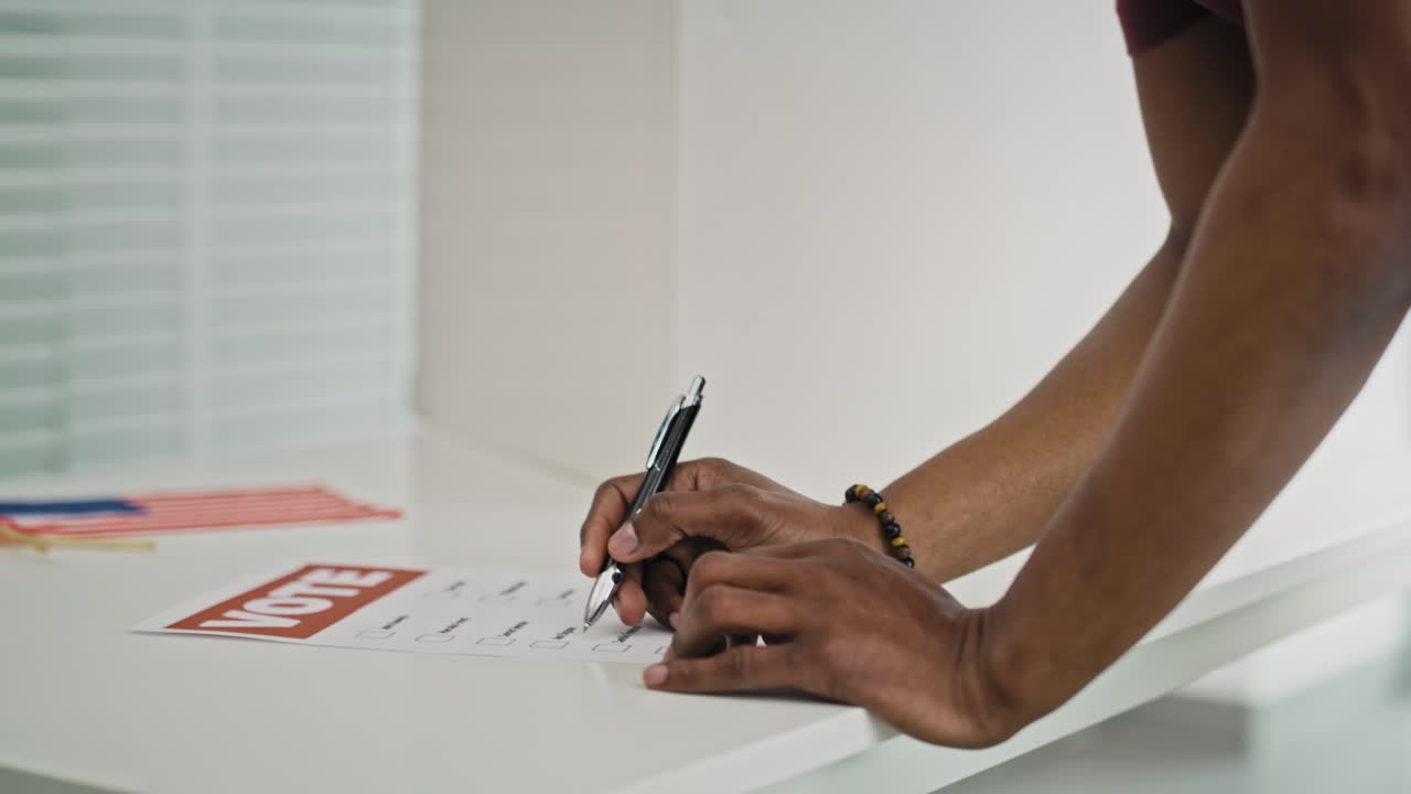 Tilt down video of man voting in face mask