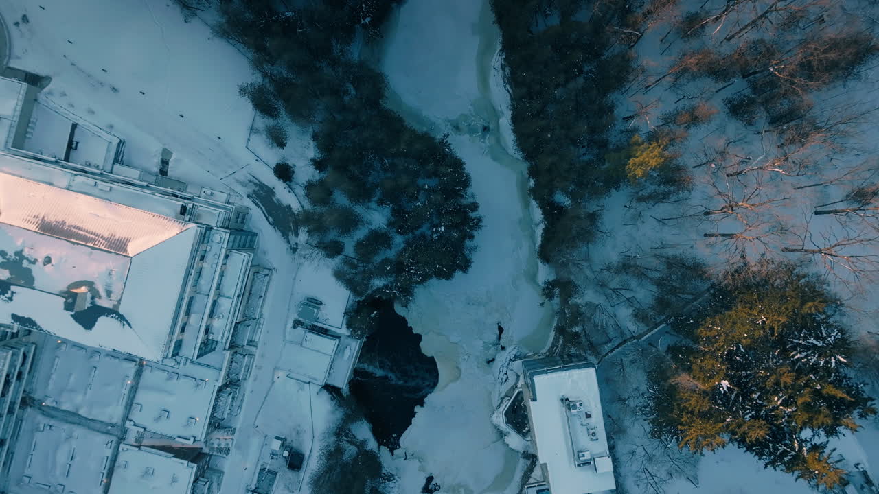 Aerial view of snowy Elora Gorge and town buildings in winter, Ontario