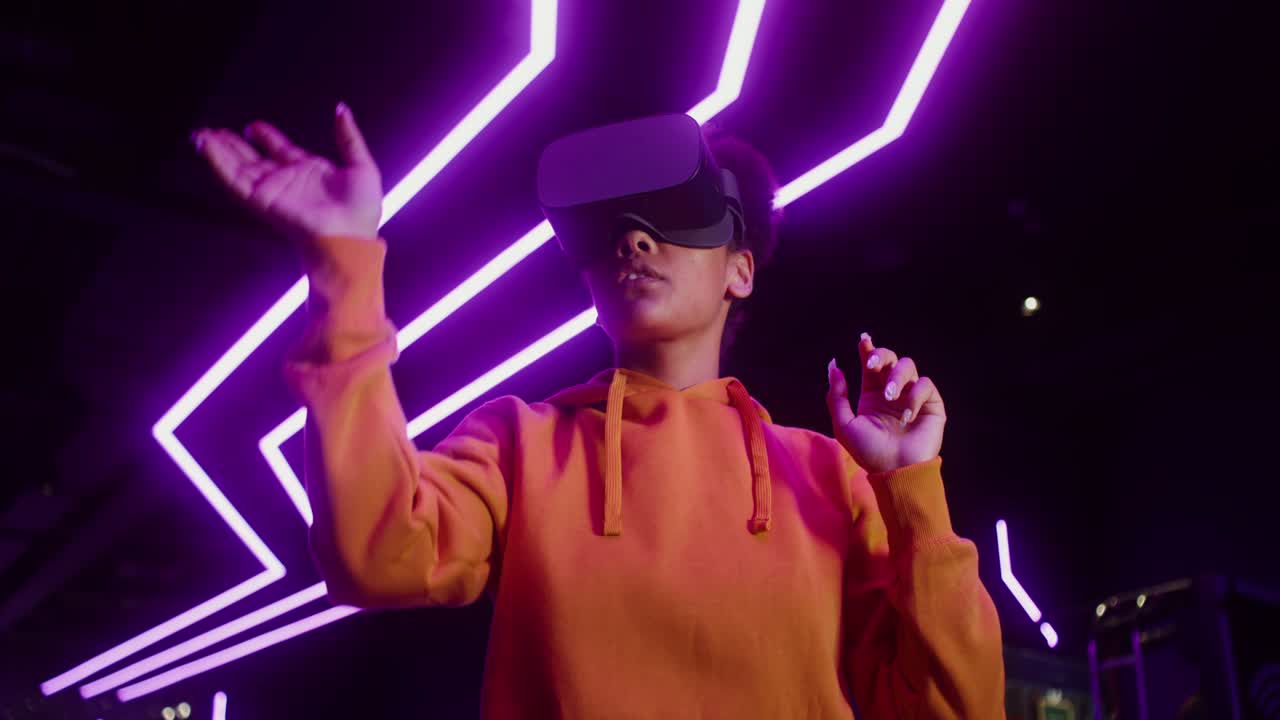 Woman using VR headset in a neon lit environment
