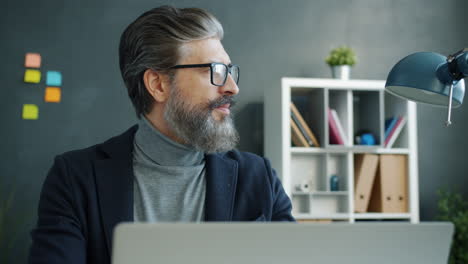 man working on laptop in office
