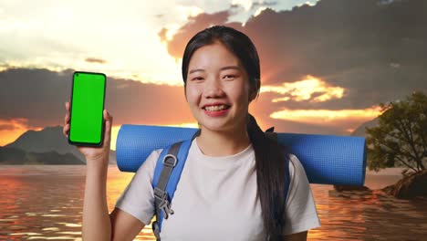 Woman with Backpack and Phone at Sunset by the Lake