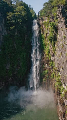 aerial view of a majestic waterfall cascading between lush cliffs, captured in a serene, natural