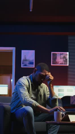 vertical video tired black man failing some tasks and struggling to focus at home