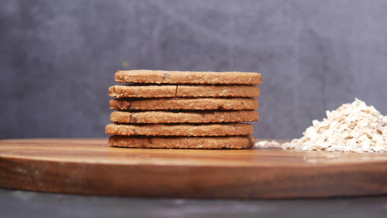 Stack of chocolate cookies on wooden background