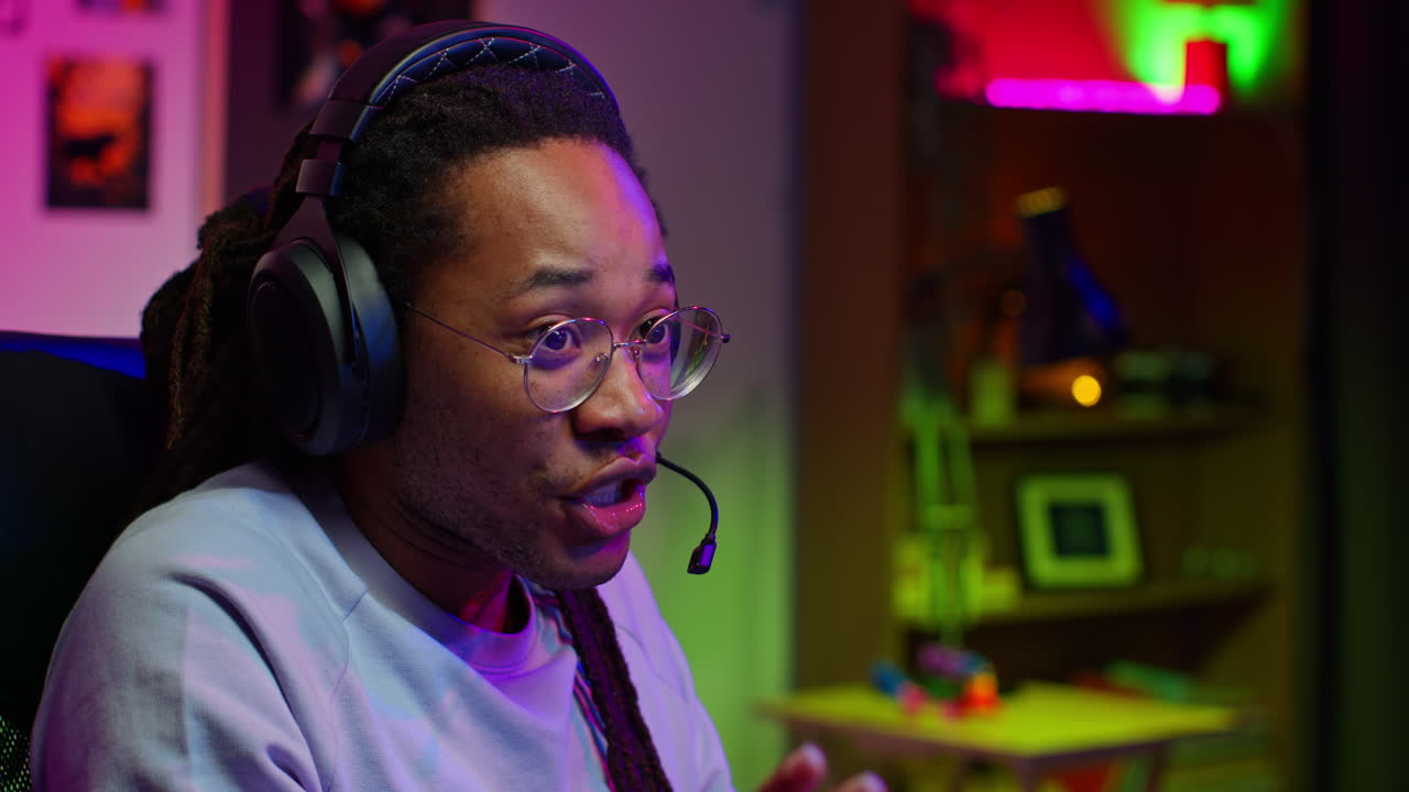 Man playing a video game with headphones and a microphone