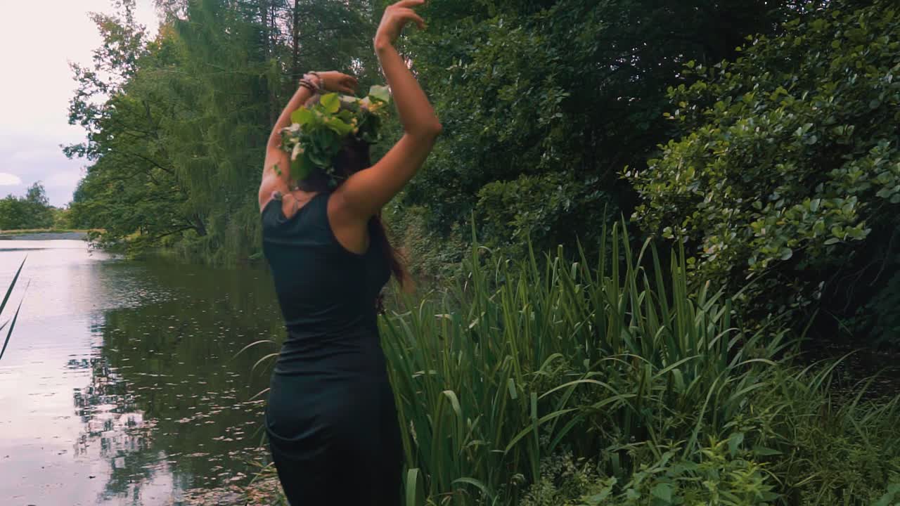 Sexy Hippy woman in dress wearing flower headdress dancing feeling one with nature