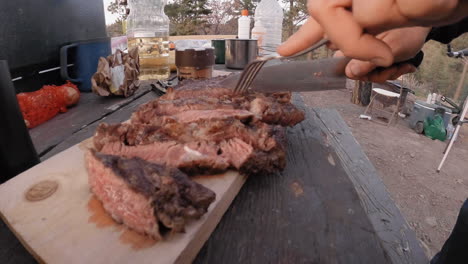 cutting a steak outdoors