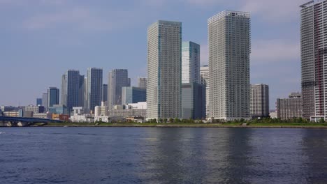 tokyo bay area, establishing shot of skyscrapers from toyosugururi park 4k