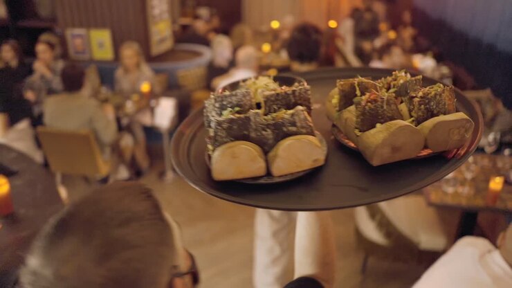 Waiter Serving Food in a Restaurant