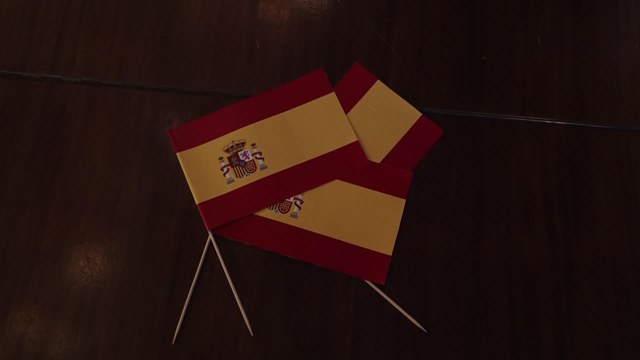 Spanish flags on a dark wooden surface at a festive party celebration