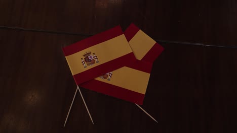 spanish flags on a dark wooden surface at a festive party celebration