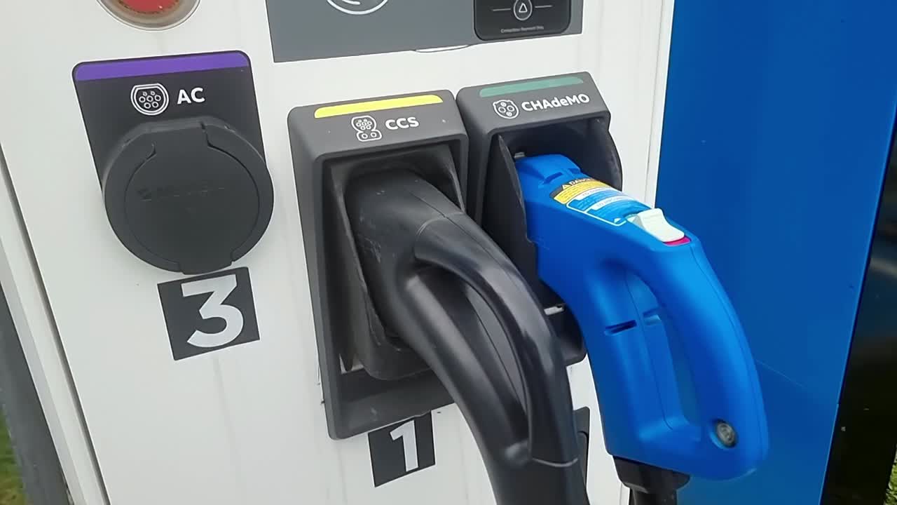 Electric vehicle power charging station energy payment point in modern infrastructure car park