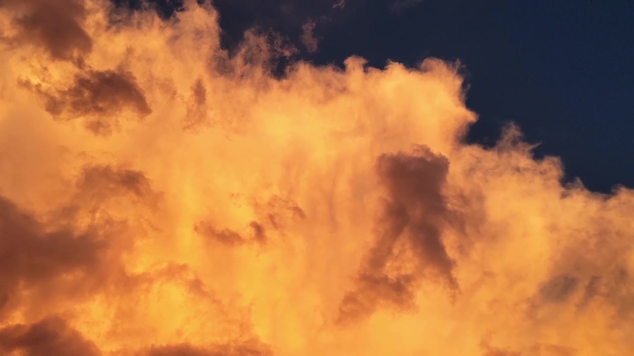 Dramatic stormy clouds moving at sunset