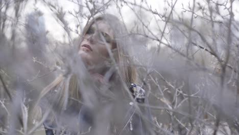 woman in a black leather jacket in the branches of a tree