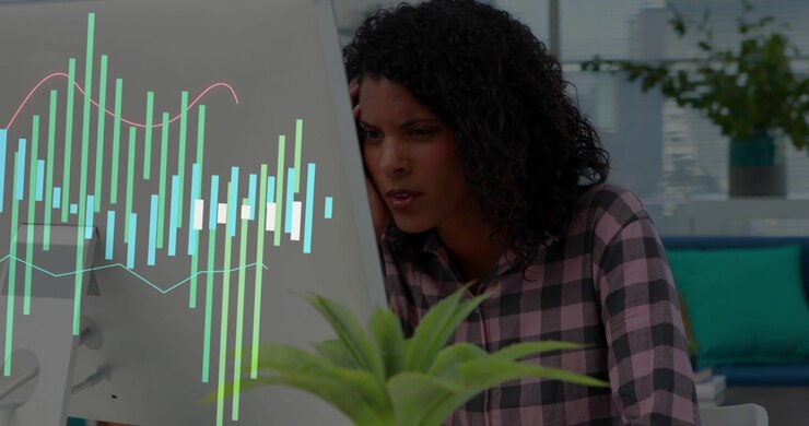 Woman leaning at desk tech overlay emerging on monitor calling phone using headset monitoring audio