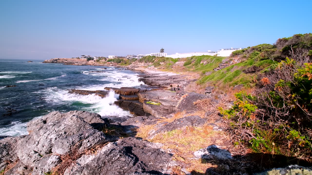 Scenic rugged coastline of Hermanus on Cape Whale Coast with crashing waves