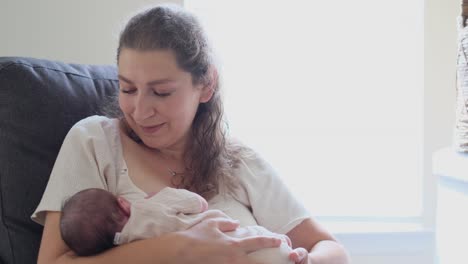 loving mother tenderly cherishing newborn infant in cozy setting a loving mother tenderly cherishes her newborn infant in a cozy warm space brimming with joy and bliss