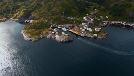 lofoten islands, northern norway with red fishing huts. iconic landscape and village, green mountains, boat