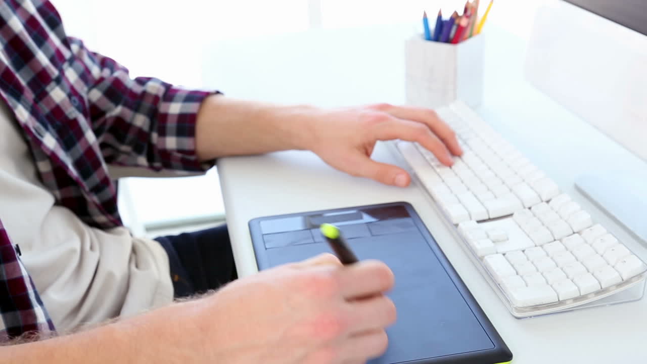 Graphic designer using digitizer at his desk