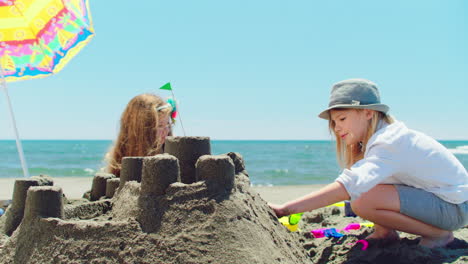 children building sandcastles on the beach