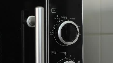 setting wattage on microwave to 700w - close up - angled shot