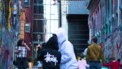 people exploring graffiti-covered hosier lane