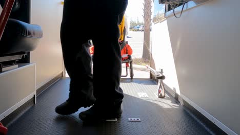 emt sweeping out back of ambulance viewed from near floor