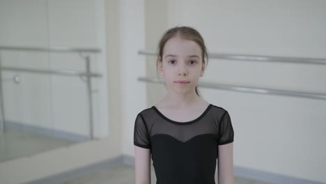 young ballerina practicing dance moves in studio