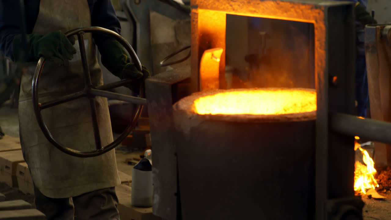 Workers melting metal in foundry workshop 4k