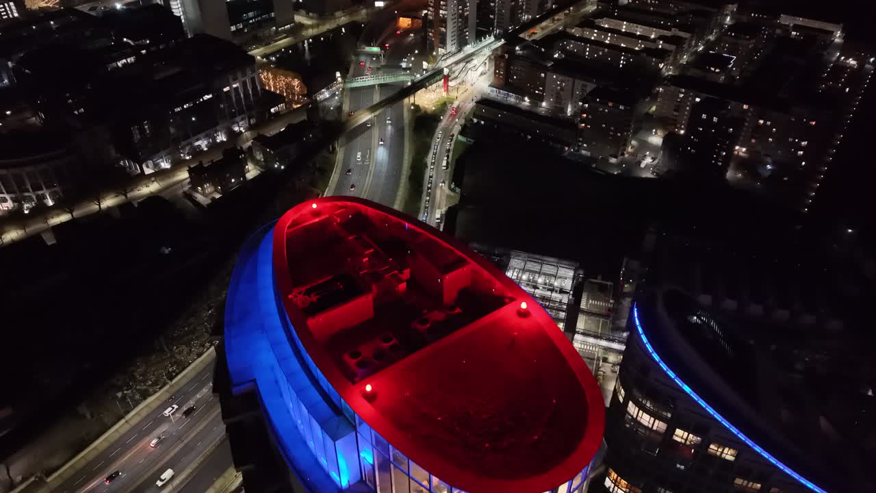 Everning East London highway drone push in over colourful apartment building