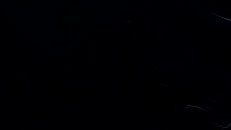 bandeira preta agitando no vento animação em câmera lenta. 4k textura de tecido realista bandeira soprando suave em um dia ventoso fundo de loop contínuo sem costura.