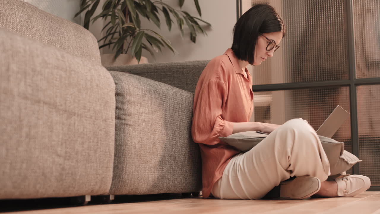 Woman Using Computer Sitting on Floor