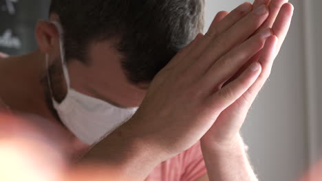 tired frustrated man with mask shaking his head, close portrait dolly shot