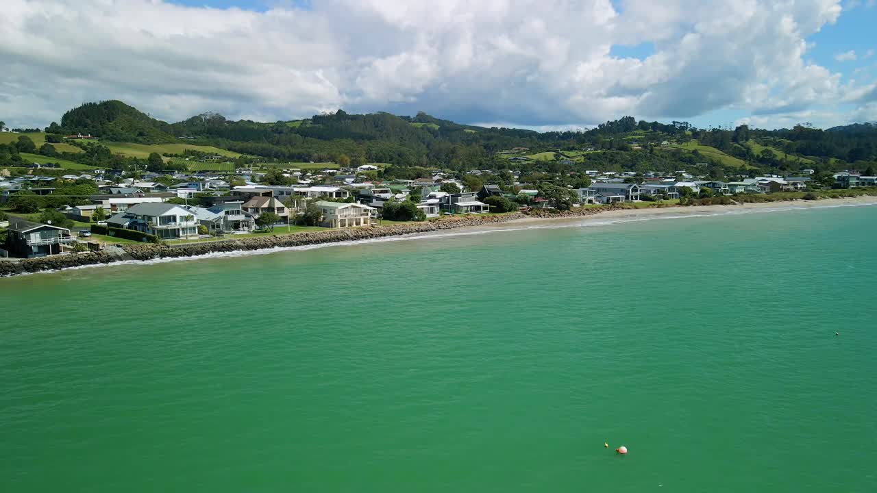 vista aérea de propiedades de lujo frente a la playa en cooks beach, nueva zelanda