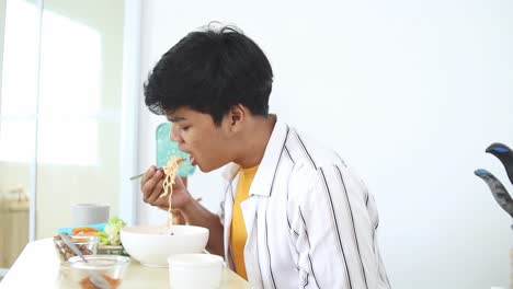 Young man eating a meal at home