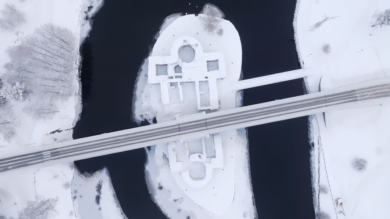 Birds eye drone shot rotating above the Kajaani castle, winter day in Finland